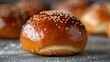 Intimate view of a pretzel bun's golden crust and salt topping, ready for making burgers, isolated background, studio lit