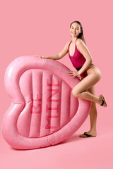 Sticker - Young woman with inflatable mattress and phrase BE MINE on pink background