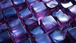 © wiwid - This close-up photo of purple glass beads in different shapes and sizes reveals their sparkling beauty. The beads are arranged in a way that creates a sense of depth and movement