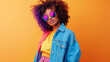 © Nadezhda Mih - Retro 90s fashion portrait of African American woman with sunglasses on orange background. Vintage female dressed in 1990s style denim clothing.