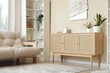 © Pixel-Shot - Wooden chest of drawers, shelving unit and comfortable sofa in interior of modern living room