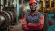 © Ali - portrait of a smiling worker standing in a industrial factory, worker wearing safety helmet looking at camera