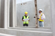 © DG PhotoStock - Engineer team discuss and examine a building construction.