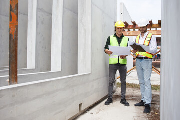 Engineer team discuss and examine a building construction.