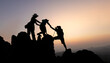 © Tinnakorn - Silhouette of teamwork of three mountain climbers helping each other on the mountain top, climbing team, Hiking, friendship as a team, helping each other,  helping in the mountains, sunrise.