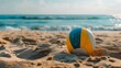 a volleyball ball lies on the sand by the sea, free space on the left, summer sports, volleyball 