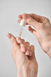 © kirill87 - Women's hands apply cuticle oil with a pipette