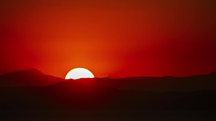 Wall Mural - Full Moon Rising Against Red Horizon Over Mountains. Timelapse