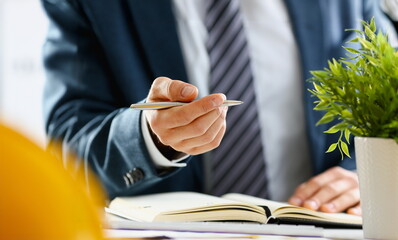 Wall Mural - Male arm in suit and tie hold silver pen filling schedule in notepad at office workplace closeup. Legal law consult assistance gesture or finance investment advisor clerk job information gesture