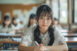 © Hamza - Japanese Schoolgirl Taking Notes Writing Essay Learning In Classroom, Panorama