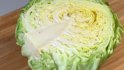 Wall Mural - Half of white cabbage on cutting board, close-up