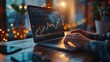 © Werckmeister - Businessman's hand working on a laptop with graphic graph chart diagram, stock market on the screen.