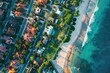 © anatolir - Topdown shot of a sunlit neighborhood by the ocean, showcasing homes and clear blue waters