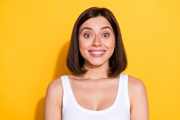 Wall Mural - Photo portrait of attractive young girl cheerful excited smile wear trendy white outfit isolated on yellow color background