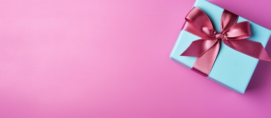 Poster - Gift box with ribbon and bow on color background and space for text Top view. copy space available