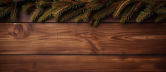 Canvas Print - green spruce branch with Christmas decor on a brown wood background empty space. copy space available