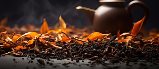 A black tea leaves copy space image with dry tea leaves and dry orange zest