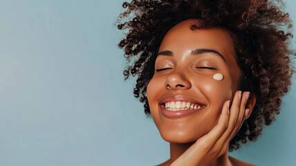 Wall Mural - a happy young woman with bare shoulders enjoys a pampering skincare routine, applying serum to her face with a gentle touch and a contented smile.