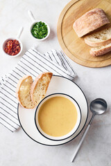 Wall Mural - Bowl of potato soup with parsley with toasted bread croutons in white bowl. Comfort meal, vegetarian food concept