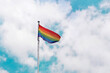 © Iryna - waving rainbow pride flag in cloudy sky