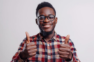 Wall Mural - Image of a happy black male in casual clothes giving thumbs up on white studio background