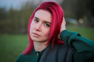 A beautiful girl walks on a green field. Posing in nature. 