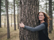 © DayfaPhoto - Joyful Woman Hugging Tree in Forest
