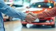 © Elena - Car seller and buyer handshake at car dealership against new red car. Auto business, success deal at salon