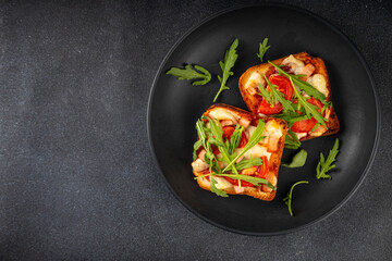 Wall Mural - Tasty crunchy toasts pizza. Fast food, modern variation of portioned quick made pizza on toast bread with tomato, bacon, mozzarella cheese and arugula, copy space