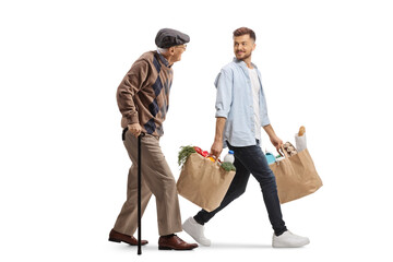Wall Mural - Young man carrying grocery bags and talking to an elderly man