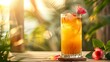 © Tida - Refreshing orange drink with rose in sunshine - Sunlit image of a cold beverage with ice and a small red rose garnish on a wooden surface