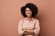 © Markus Schröder - Portrait of a satisfied afro-american woman in her 20s with arms crossed in front of soft brown background