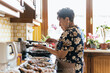 © ADDICTIVE STOCK - Senior Woman Preparing a Meal in Her Kitchen
