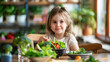 © OMD - A young girl sits at a wooden table filled with fresh vegetables, including broccoli, tomatoes, and leafy greens, indicating healthy eating in a cozy, greenery-filled room.