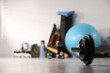 © New Africa - Dumbbell and other sports equipment indoors, closeup. Space for text