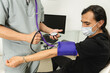 © ADDICTIVE STOCK - Health monitoring: blood pressure check during medical consultation