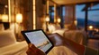 © GENi - A guest browses a digital room service menu displayed on a tablet in the hotel room, customizing their order and selecting delivery time.