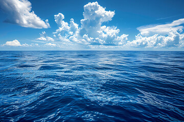 Canvas Print - Expansive view of the deep blue ocean under a sky filled with cumulus clouds. Seascape photography for travel and nature concepts. Design for poster and wallpaper. Wide shot