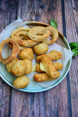 Wall Mural - Selection of fast food snack. italian cheese breaded Mozzarella Sticks, Jalapeno Cheese nuggets, Onion Rings and mayo sauce.Italian street junk food