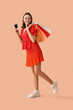 © Pixel-Shot - Young woman with credit card, mobile phone and shopping bags on beige background