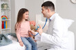 © Pixel-Shot - Male pediatrician with inhaler listening to lungs of little girl in bedroom