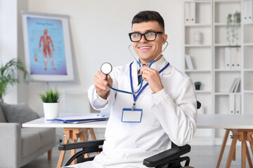 Poster - Young male doctor in wheelchair with stethoscope at hospital