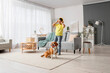 © Pixel-Shot - Little African-American boy and cute beagle dog with headphones listening to music at home