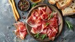 © Vasiliy - Slices of prosciutto di parma or jamon serrano (iberico) on a black plate
