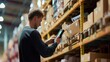 © InfiniteFlow - Professional project manager hands looking tablet while checking product at warehouse. Start up smart business man working on tablet while walking at storage with blurring background. Business. AIG42.