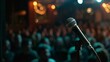 © SH Design - Photo of a microphone on stage with an audience in the background, capturing comedy club photography. Web banner with empty space on the right.