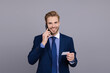 © be free - Credit or debit card. Businessman talking on phone isolated on grey. Businessman card for phone call. Business communication online. Business name card. Phone call to online banking. Customer support