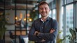© yj - smiling young businessman in a casual outfit with his arms crossed standing at an office, happy posing for a photo on a modern interior design. generative AI