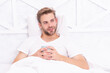 © be free - Breakfast in bed at cozy hotel room. Man with coffee in bed. Morning at home. Weekend wakeup. Man relax with hot drink in bedroom. Man relax in bed with morning coffee. Waking Up With Good Mood
