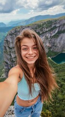 Poster - A woman with long brown hair is smiling and taking a selfie. She is wearing a blue tank top and blue jeans